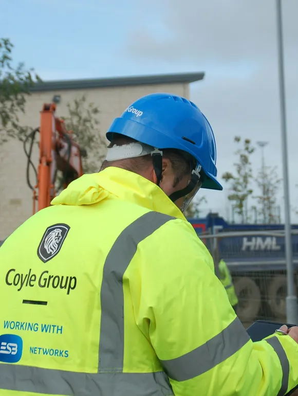 Chartered safety officer reviewing compliance documentation at an industrial power plant site